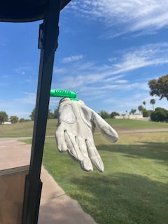 Golf club with a golf glove on a golf course